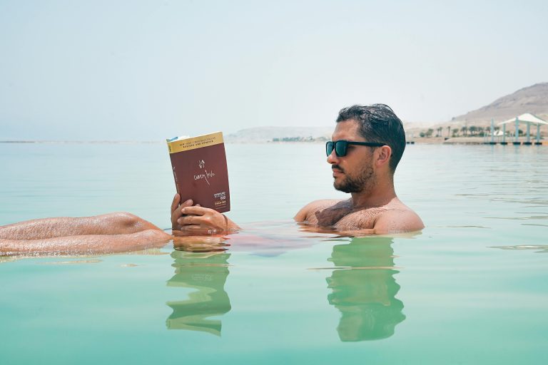 buy bye books man reading in water